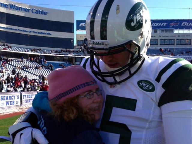 Tim Tebow and Wish 15 program recipient, Maggie, enjoys a pre-game hug before the December 30, 2012 Jets vs Bills game (Credit: Tim Tebow Foundation)