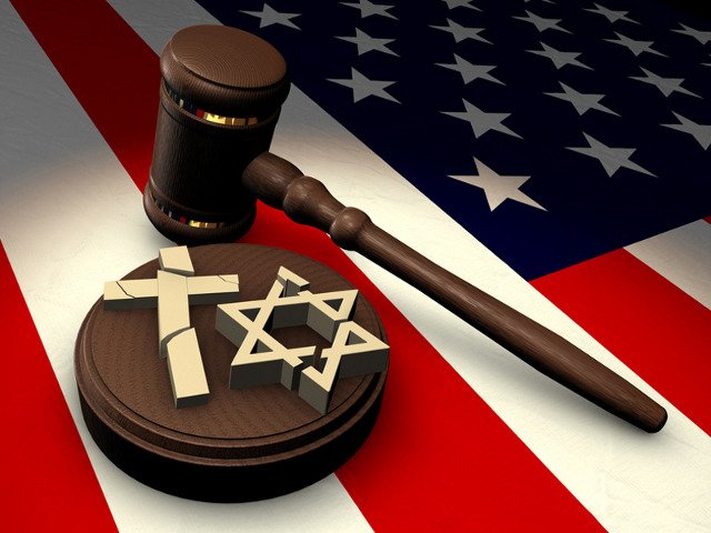 Church vs State - A gavel with a sound block that has a broken cross and Star of David on it sitting on a United States flag (Credit: James Steidl via Fotolia)
