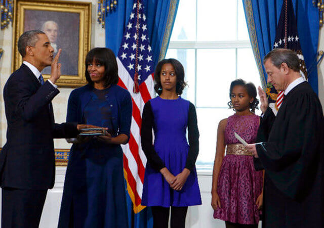 U.S President Barack Obama takes the oath of office from U.S. Supreme Court Chief Justice John Roberts as first lady Michelle Obama holds the bible and daughters Malia (3rd-L) and Sasha look on in the Blue Room of the White House in Washington, January 20, 2013. (Credit: Reuters/Larry Downing)