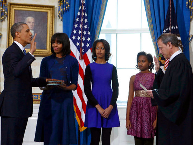 U.S President Barack Obama takes the oath of office from U.S. Supreme Court Chief Justice John Roberts as first lady Michelle Obama holds the bible and daughters Malia (3rd-L) and Sasha look on in the Blue Room of the White House in Washington, January 20, 2013. (Credit: Reuters/Larry Downing)