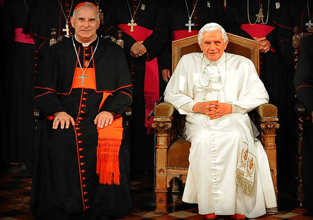 Cardinal Keith O Brien (L) sitting with Pope Benedict XVI (R) with full conclave of cardinals behind them (Credit: Catholic Church/Mazur)