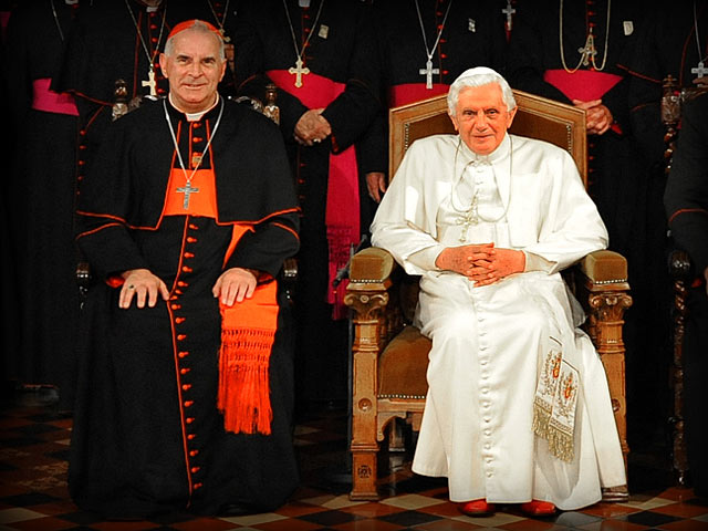 Cardinal Keith O Brien (L) sitting with Pope Benedict XVI (R) with full conclave of cardinals behind them (Credit: Catholic Church/Mazur)