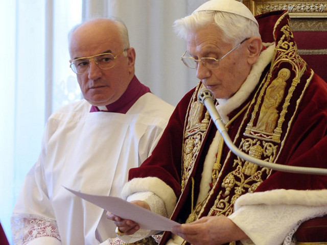 Pope Benedict XVI announcing his resignation on Monday at the Vatican. At left is Msgr. Franco Camaldo, a papal aide (Credit: L'Osservatore Romano via Associated Press)
