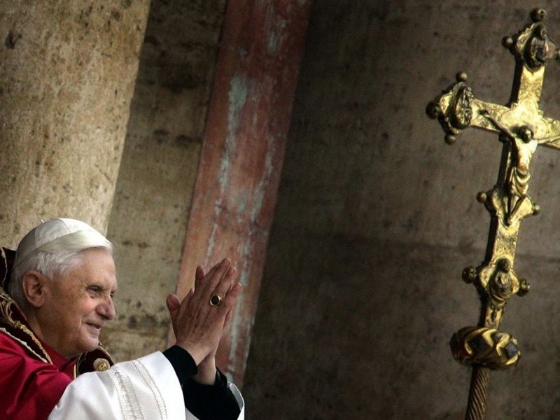 The newly elected Pope Benedict XVI, formally known as German Cardinal Joseph Ratzinger, blesses thousands of pilgrims from the balcony of the St. Peter's Basilica at the Vatican, April 19, 2005 (Credit: Reuters/Kai Pfaffenbach)