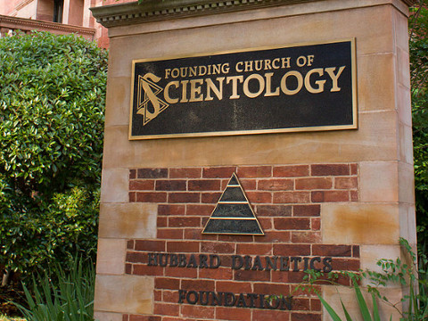 A facade with a plaque outside the founding church of Scientology in Washington, DC (Credit: Victor Grigas via en.wikipedia.org)