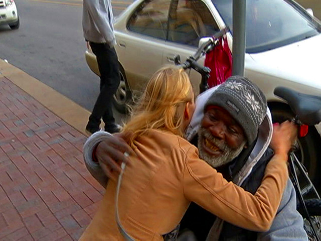 Bill Ray Harris, a homeless man in Kansas City, hugs Sarah Darling after returning her wedding ring to her after she accidently placed it in the man's donation cup (Credit: KCTV5News)