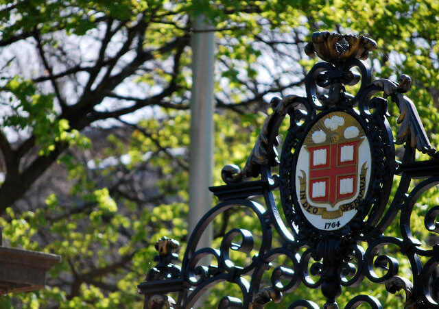 The Brown University crest that sits atop the Van Wickle Gates, the ornamental entrance to the main campus area at the corners of College Street and Prospect Street in College Hill on the east side of Providence, Rhode Island, April 14, 2010 (Credit: David M via Flickr)
