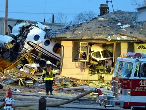 South Bend police and fire officials examine a home where a a plane crash occurred near the South Bend Regional Airport Sunday March 17, 2013 in South Bend, Ind (Credit: WSBT)