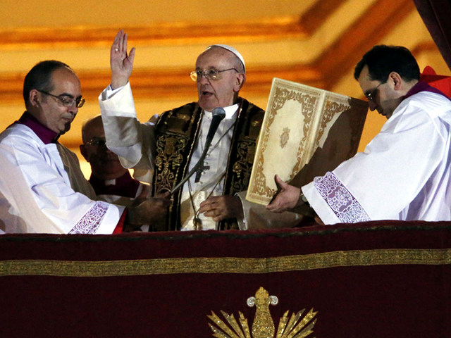 Newly elected Pope Francis (C), the 266th pontiff of the Roman Catholic Church, former Cardinal Jorge Mario Bergoglio of Argentina, appears on the central balcony of St. Peter's Basilica at the Vatican to bless the crowd after being elected by the conclave of cardinals, at the Vatican, March 13, 2013 (Credit: Reuters / Tony Gentile)