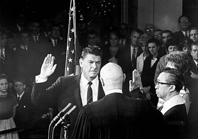 Republican Ronald Reagan is sworn in as governor of California as he takes the oath of office from California State Justice Marshall F. McCombs in Sacramento, California, January 2, 1967 (Credit: AP)