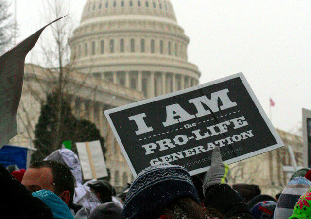 A participant in the annual March for Life rally holds up sign 'I am the Pro Life Generation' outside the Capitol Building in Washington, January 25, 2013 (Credit: LiveAction.org via Flickr)