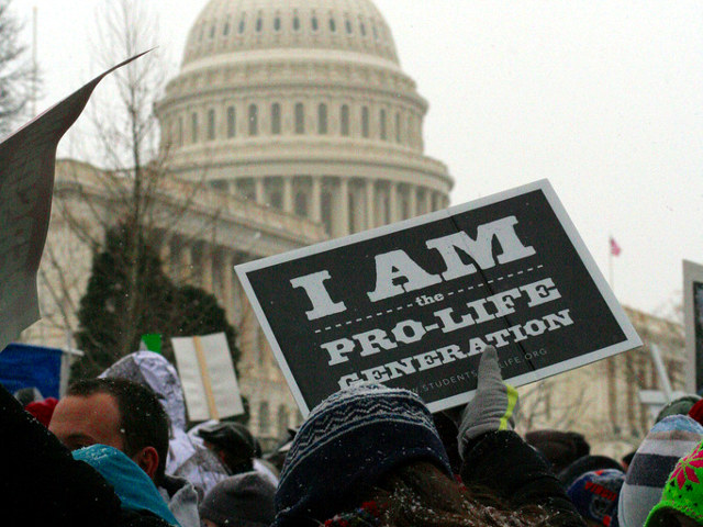 A participant in the annual March for Life rally holds up sign 'I am the Pro Life Generation' outside the Capitol Building in Washington, January 25, 2013 (Credit: LiveAction.org via Flickr)