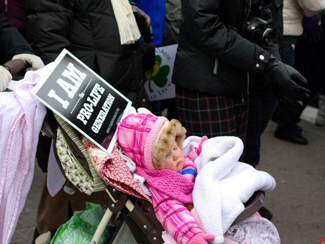 A participant in the annual March for Life rally pushes her child in a stroller as the rally marches towards the U.S. Supreme Court building in Washington, January 25, 2013  (Credit: LiveAction.org via Flickr)