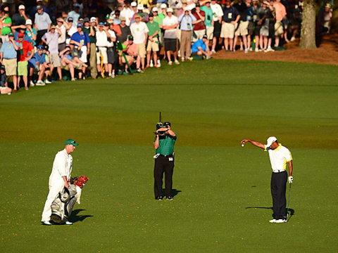 Tiger Woods takes a drop after his approach shot hit the flag stick and rolled back into the water at the 2013 Masters Tournament at Augusta National, April 13, 2013 (Credit: John W. McDonough /Sports Illustrated)