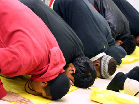 Hayat and Habeeb Marso along with their fellow classmates of Parkdale High School Muslim Student Association praying in a classroom during school (Credit: MuslimLink/unknown photographer)