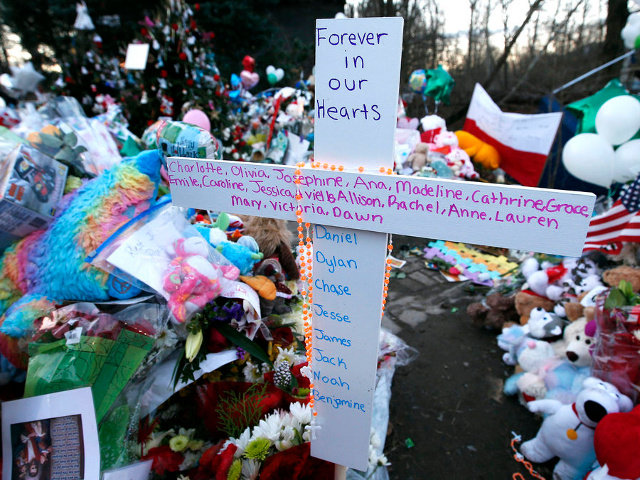 A cross bearing all the names of the victims of the shootings at Sandy Hook Elementary School in Newtown Connecticut December 14, stands at a makeshift memorial for victims of the shootings in Sandy Hook village in Newtown (Credit: Reuters/Mike Segar)