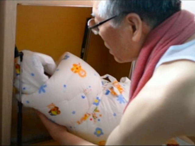 Lee Jong-rak, pastor of Jesus-Loving Union Church in Seoul, South Korea, removes an unwanted child placed in a drop box outside his orphanage by a mother who did not want the child (Credit: Brian Ivie)