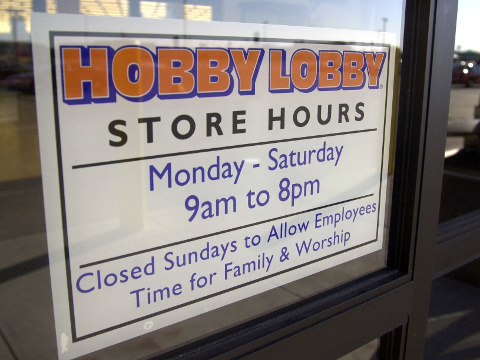 A store hours sign, in a Michigan Hobby Lobby store window, showing that Hobby Lobby is closed on Sundays (Credit: MLive)