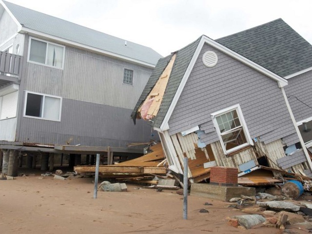 People view one of many homes badly damaged by Hurricane Sandy is pictured in the Cosey Beach neighbourhood of East Haven, Connecticut, October 30, 2012 (Credit: Reuters/Michelle McLoughlin)