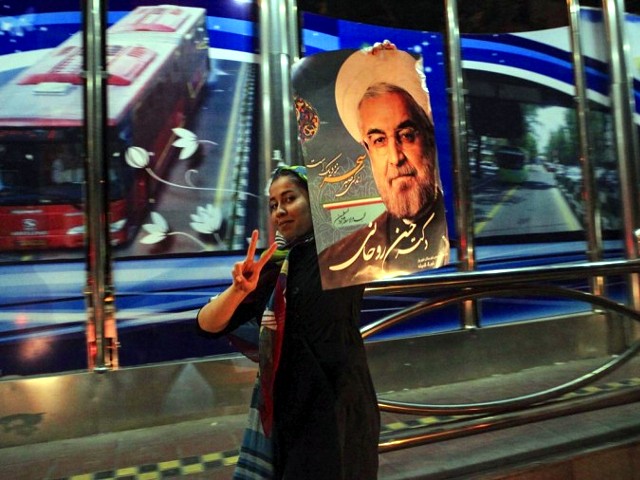 A supporter of moderate cleric Hassan Rohani celebrates his victory in Iran’s presidential election along a street in Tehran June 16, 2013. Rohani won Iran’s presidential election on Saturday, the interior ministry said, scoring a surprising landslide victory over conservative hardliners without the need for a second round run-off. (Credit: Yalda Moayeri)