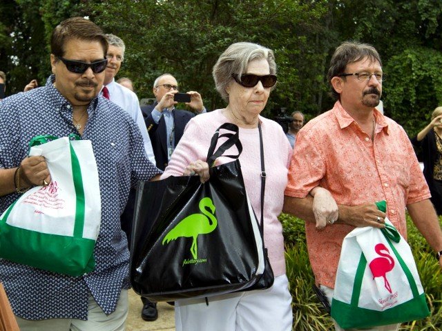 Gloria C. Mackenzie, an 84-year-old woman from Zephyrhills, Florida (C), her son Scott (R) and a person identified by Lottery Officials as a trusted family friend (L) leave the Florida Lottery offices after claiming the largest single jackpot in American lottery history, valued at $590 million, in Tallahassee, June 5, 2013 (Credit: Reuters/Colin Hackley)