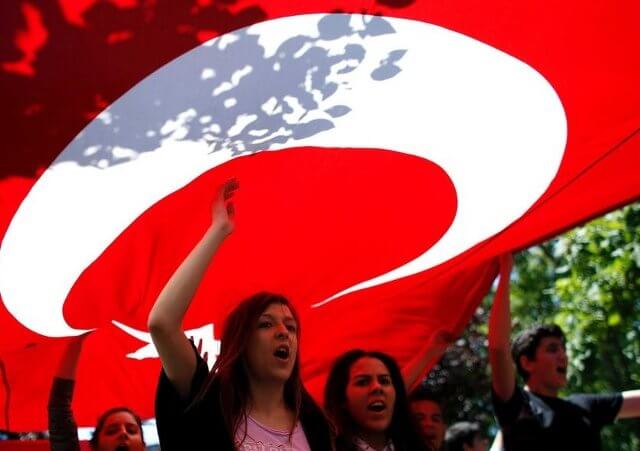 Protesters carry the Turkish flag and shout anti-government slogans during a demonstration at Gezi Park near Taksim Square in central Istanbul on June 3, 2013 (Credit: Reuters/Stoyan Nenov)