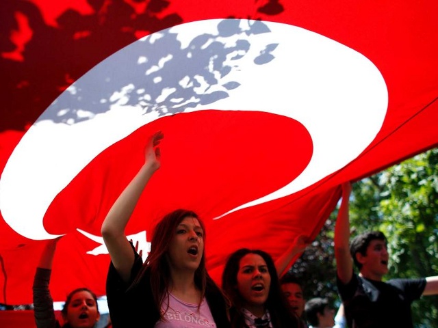 Protesters carry the Turkish flag and shout anti-government slogans during a demonstration at Gezi Park near Taksim Square in central Istanbul on June 3, 2013 (Credit: Reuters/Stoyan Nenov)