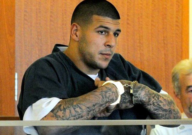 Former New England Patriots football tight end Aaron Hernandez stands during a bail hearing in Fall River Superior Court, June 27, 2013 in Fall River, Massachusetts (Credit: Boston Herald/Ted Fitzgerald)