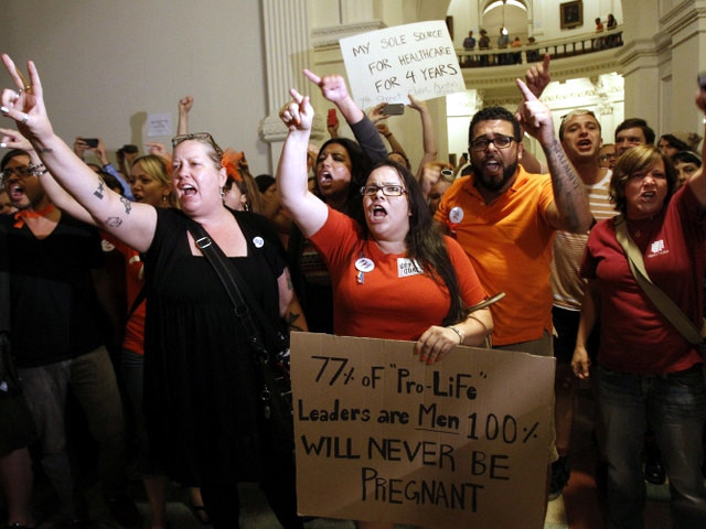Abortion rights activists demonstrate outside the floor of the House after the HB2 bill restricting abortion rights passed in Austin, Texas July 9, 2013 (Credit: Reuters/Mike Stone)