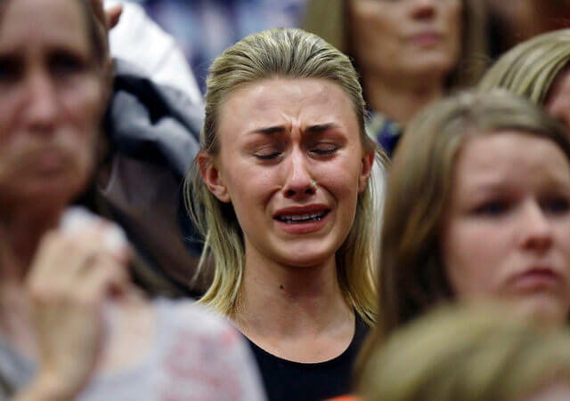 A woman cries during a memorial service for the 19 firefighters who perished battling a fast-moving wildland fire, in Prescott, Arizona July 1, 2013 (Credit: Reuters/Joshua Lott)