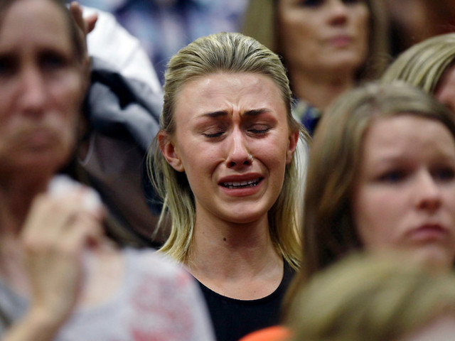 A woman cries during a memorial service for the 19 firefighters who perished battling a fast-moving wildland fire, in Prescott, Arizona July 1, 2013 (Credit: Reuters/Joshua Lott)