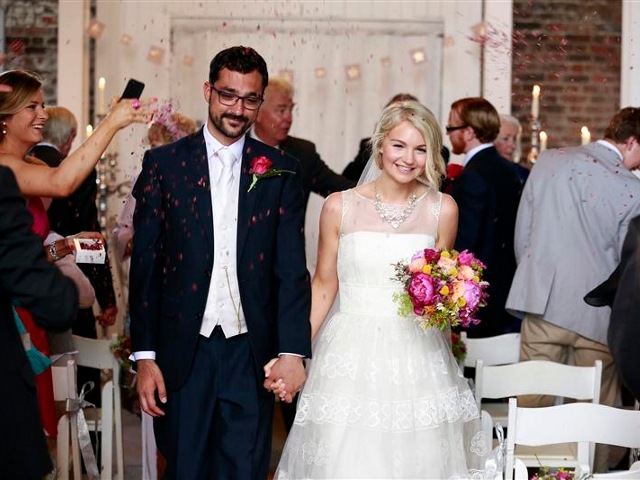 Newlyweds Brendan Hastings and Suzy Addis are covered in confetti after their humanist wedding ceremony at the Millhouse in the village of Slane, County Meath July 17, 2013 (Credit: Reuters/Cathal Mcnaughton)