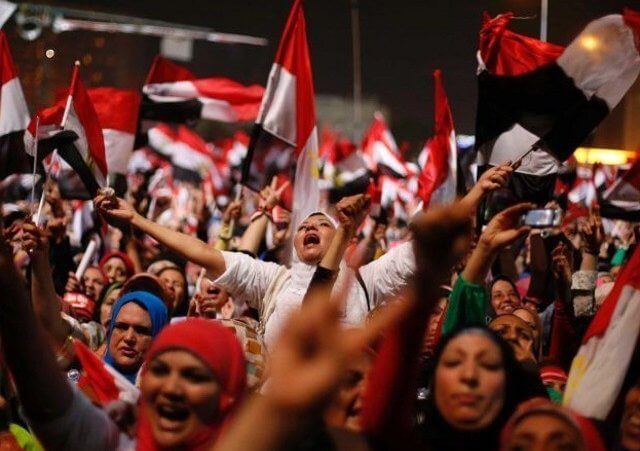 Egyptian anti-Morsi protesters react to the military announcement in Tahrir Square in Cairo on July 3, 2013. The head of Egypt's armed forces, General Abdel Fattah al-Sisi, issued a declaration on Wednesday suspending the constitution and appointing the head of the constitutional court as interim head of state, effectively removing president Mohammed Morsi from power (Credit: Reuters/Suhaib Salem)