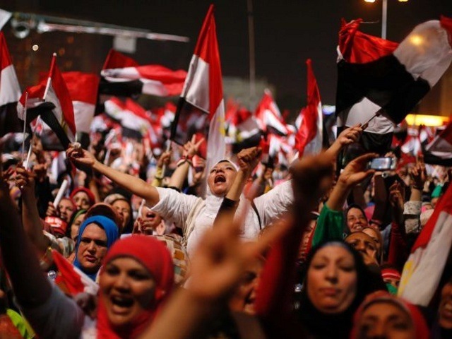 Egyptian anti-Morsi protesters react to the military announcement in Tahrir Square in Cairo on July 3, 2013. The head of Egypt's armed forces, General Abdel Fattah al-Sisi, issued a declaration on Wednesday suspending the constitution and appointing the head of the constitutional court as interim head of state, effectively removing president Mohammed Morsi from power (Credit: Reuters/Suhaib Salem)