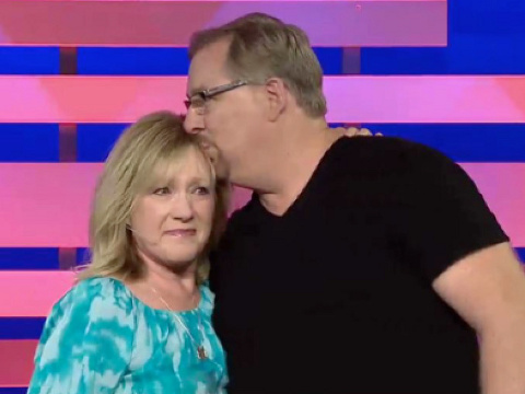 Pastor Rick Warren kisses wife Kay after they come to the stage for Warren's first sermon, on July 27, 2013, since the death of his son in April (Credit: Saddleback Church)