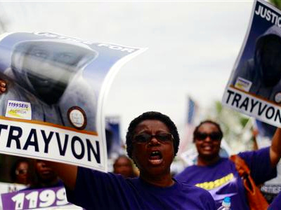 Demonstrators hold signs aloft as they march during an NAACP march and rally to the front of the Sanford Police Department for Trayvon Martin in Sanford, Florida, March 31, 2012 (Credit: Reuters/Lucas Jackson)