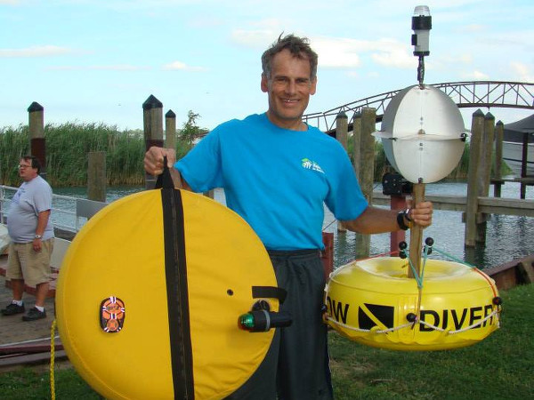 Jim Dreyer holding GPS and beacon for his 22 mile swim, hauling 1 tone of bricks (Credit: Jim Dreyer's Facebook page)