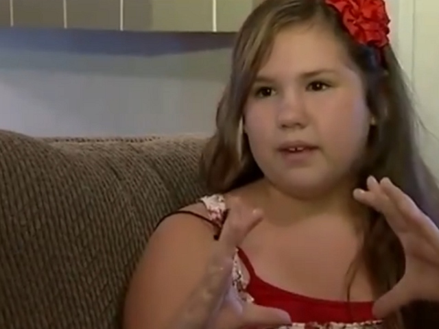 Riley Breihan estimates the size of the shark that attacked her in knee deep water off Ponce Inlet during an interview with WESH Channel 2 (Credit: WESH)