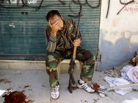 A Free Syrian Army fighter reacts after his friend was shot by Syrian army soldiers (Credit: Reuters/Goran Tomasevic)