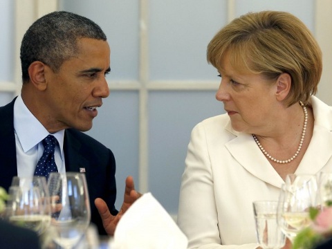 U.S. President Barack Obama and German Chancellor Angela Merkel (R) chat during dinner at the Chralottenburg Castle in Berlin June 19, 2013 (Credit: Reuters/Michael Sohn)