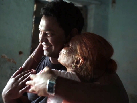 A video screen grab from a video directed, shot and edited by Henry Chen and Ssongee Yang and produced by Stephen Higgins and Google, showing Saroo Brierly, separated from his birth mother for 25 years, as she kisses him on the cheek in his birth home in Khandwa, Madhya Pradesh, India (Credit: Google/Henry Chen/Ssongee Yang/Stephen Higgins)