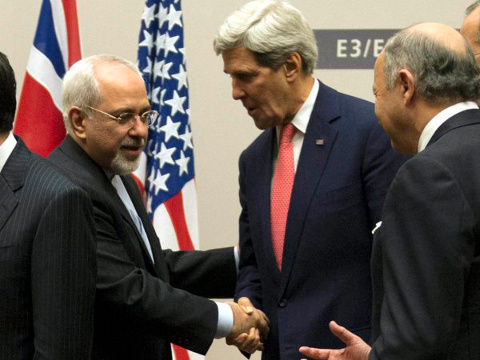 US Secretary of State John Kerry shakes hands Sunday with Iran's Foreign Minister Javad Zarif in Geneva after a third round of negotiations on Iran's nuclear program led to a historic initial nuclear deal between Iran and six world powers (Credit: EPA/Martial Trezzini)
