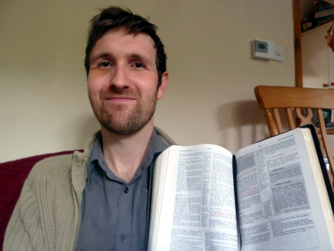 Chris Juby holding the Bible he used to summarize and tweet each chapter of the Bible (Credit: Chris Juby)