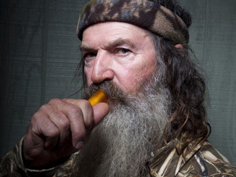 Phil Robertson of A&E's Duck Dynasty with his famous duck call (Credit: A&E via Facebook)