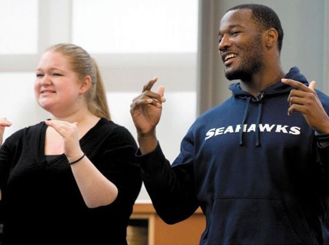 Seahawks running back Derrick Coleman talks to students at Baker Middle School in Tacoma about how he's gained success despite a hearing impairment, December 10, 2013 (Credit: The News Tribune/Joe Barretine)
