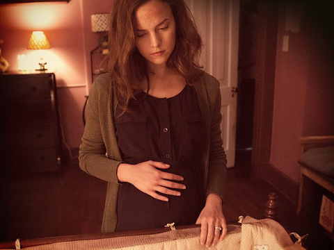 Allison Miller as Samantha McCall, early in her pregnancy, standing over a crib in a scene from the upcoming Twentieth Century Fox movie, Devil's Due (Credit: Twentieth Century Fox)