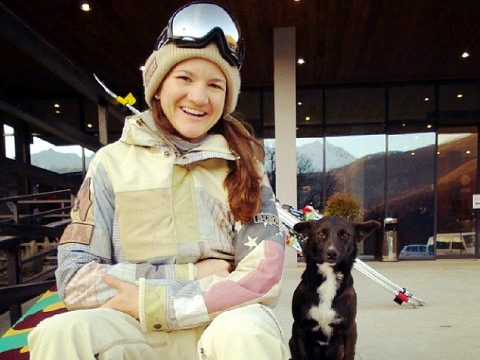 Kelly Clark, the 30 year old American snowboarder and 2014 Olympic bronze medalist, poses for a photo with the Team USA puppy, days before her event in the Olympic village (Credit: Kelly Clark via Instagram)