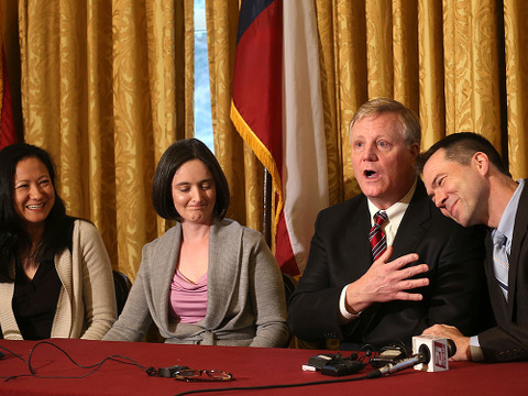 Gay couples from left, Cleopatra De Leon and Nicole Dimetman, and Mark Phariss and Victor Holmes, give a news conference in San Antonio on Wednesday, Feb. 26, 2014 after U.S. Federal Judge Orlando Garcia declared a same-sex marriage ban in deeply conservative Texas unconstitutional (Credit: San Antonio Express-News/ Jerry Lara)