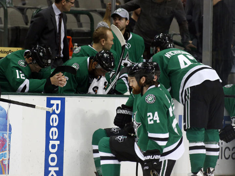 Dallas Stars right wing Alex Chiasson (12) bows his head on the bench as defenseman Jordie Benn (24) takes a knee on the ice after play was stopped in the first period of an NHL Hockey game against the Columbus Blue Jackets, Monday, March 10, 2014, in Dallas. Stars center Rich Peverly was taken to a hospital after a medical emergency. (Credit: AP/Sharon Ellman)