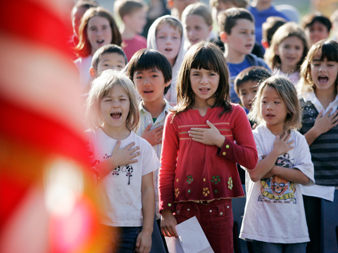 Fairmeadow Elementary School students recite the Pledge of Allegiance during a school assembly in Palo Alto (Credit: AP/Paul Sakuma)